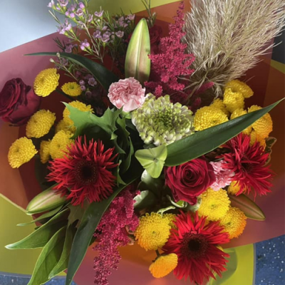 Confetti - A vibrant handtied bouquet in water presented in a gift box/bag. Created using yellow, pink and green flowers with complimentary foliage. Hand delivered with care in and around Newcastle by Fantasia Florist.